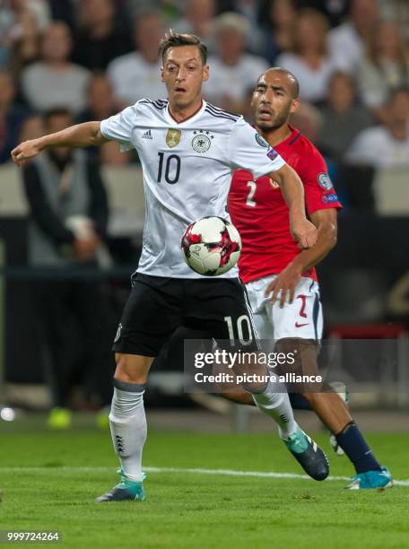 Germany's Mesut Oezil and Norway's Haitam Aleesami vie for the ball during the soccer World Cup qualification group stage match between Germany and...