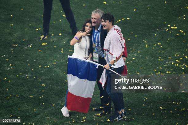 France's coach Didier Deschamps poses with his wife, Claude, and son, Dylan , as he celebrates after the Russia 2018 World Cup final football match...