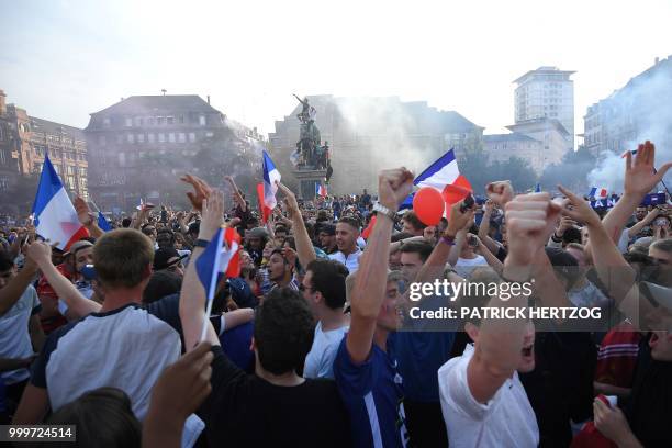 Peopler celebrate after France won the Russia 2018 World Cup final football match between France and Croatia, on July 15, 2018 in Strasbourg, eastern...