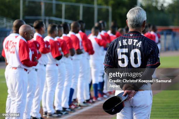 Manager Tsutomu Ikuta of Japan stands for the national anthem prior to the Haarlem Baseball Week game between Cuba and Japan at Pim Mulier Stadion on...
