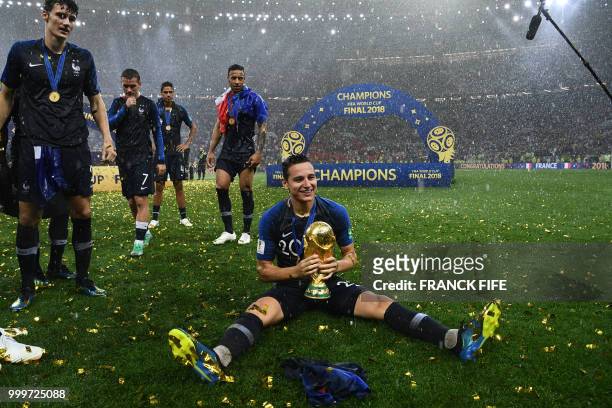 France's forward Florian Thauvin holds the World Cup trophy during the trophy ceremony at the end of the Russia 2018 World Cup final football match...