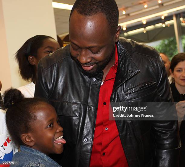 Wyclef Jean and Haiti earthquake victims attends a charity shopping spree at Kmart on May 18, 2010 in New York City.