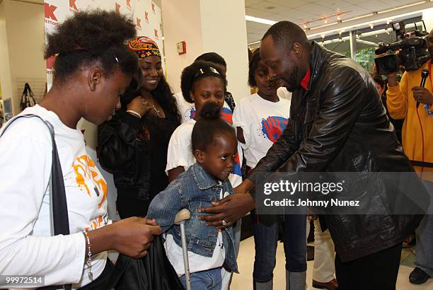 Wyclef Jean and Haiti earthquake victims attends a charity shopping spree at Kmart on May 18, 2010 in New York City.