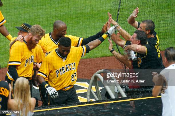 Starling Marte of the Pittsburgh Pirates and Gregory Polanco of the Pittsburgh Pirates celebrate with fans after a walk off win in the tenth inning...