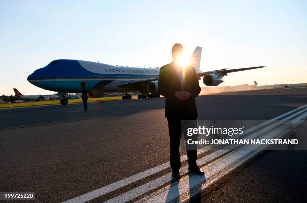 Security officer guards as Air Force One sits on the tarmac upon arrival at Helsinki-Vantaa Airport in Helsinki, on July 15, 2018 on the eve of a...