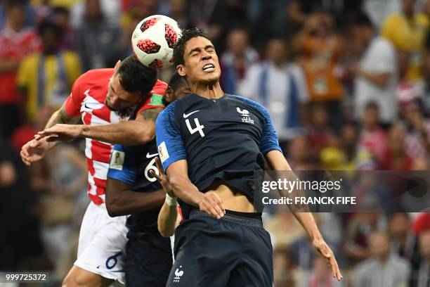 France's defender Raphael Varane vies with Croatia's defender Dejan Lovren during the Russia 2018 World Cup final football match between France and...