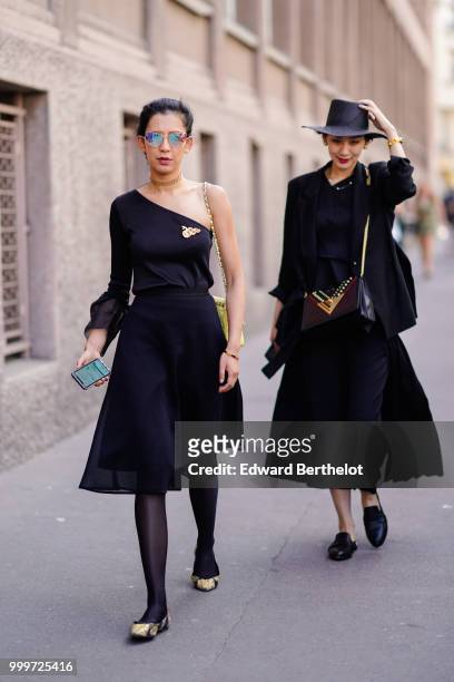 Guest wears mirror sunglasses, an off-shoulder dress, outside Wooyoungmi, during Paris Fashion Week - Menswear Spring-Summer 2019, on June 23, 2018...