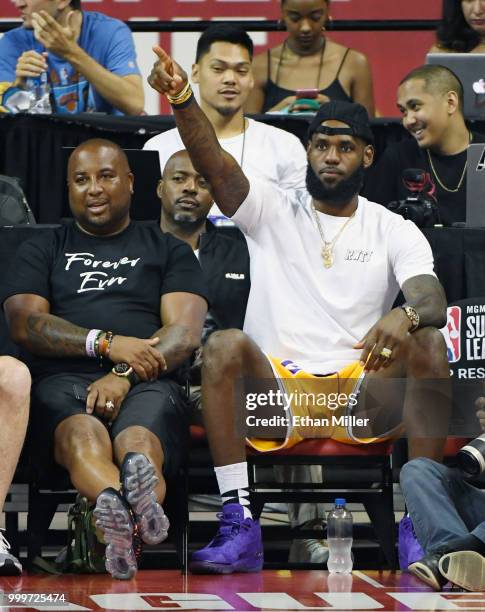 Randy Mims and LeBron James of the Los Angeles Lakers react after a dunk by Johnathan Williams of the Lakers against the Detroit Pistons during...