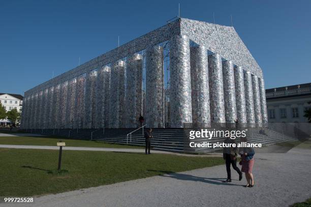 Forbidden books wrapped in plastic hang on the finalized documenta artwork 'The Parthenon of Books' in Kassel, Germany, 4 September 2017. The...