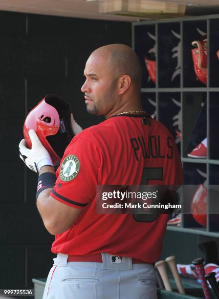 Albert Pujols of the Los Angeles Angels of Anaheim looks on from the dugout while wearing a special jersey to honor Memorial Day during the game...