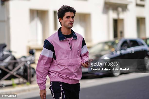 Guest wears a pink sportswear jacket, outside Wooyoungmi, during Paris Fashion Week - Menswear Spring-Summer 2019, on June 23, 2018 in Paris, France.