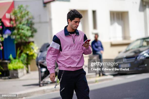 Guest wears a pink sportswear jacket, outside Wooyoungmi, during Paris Fashion Week - Menswear Spring-Summer 2019, on June 23, 2018 in Paris, France.