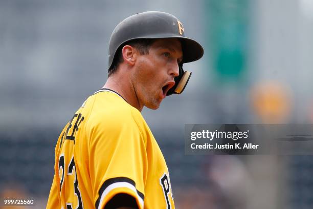 David Freese of the Pittsburgh Pirates reacts after hitting a RBI triple in the ninth inning against the Milwaukee Brewers at PNC Park on July 15,...