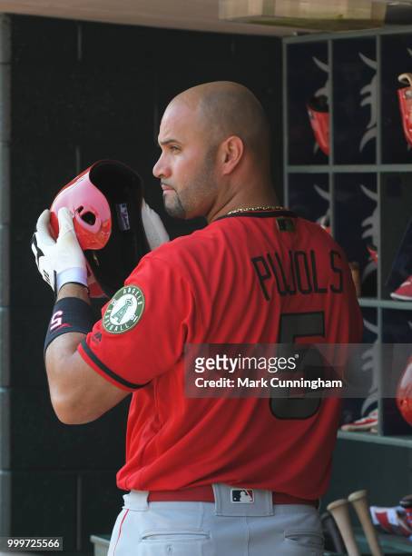 Albert Pujols of the Los Angeles Angels of Anaheim looks on from the dugout while wearing a special jersey to honor Memorial Day during the game...