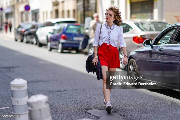 Guest wears a white shirt, a red skirt, outside Wooyoungmi, during Paris Fashion Week - Menswear Spring-Summer 2019, on June 23, 2018 in Paris,...