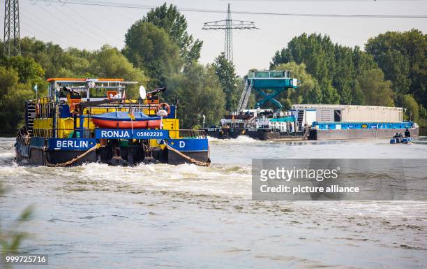 The push boats Edda and Ronja, two ships used for the transport of Castors, pass the EnBW thermal power plant in Heilbronn, Germany, 4 September...