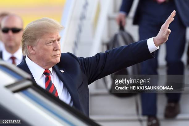 President Donald Trump waves upon arrival at Helsinki-Vantaa Airport in Helsinki, on July 15, 2018 on the eve of a summit in Helsinki between the US...