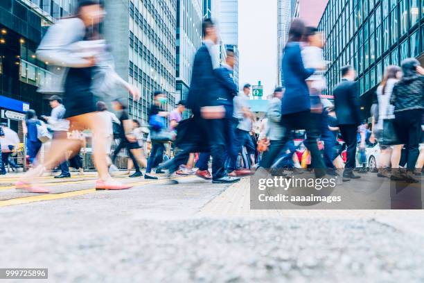 side view of pedestrains rush in hong kong - central district hong kong stock pictures, royalty-free photos & images