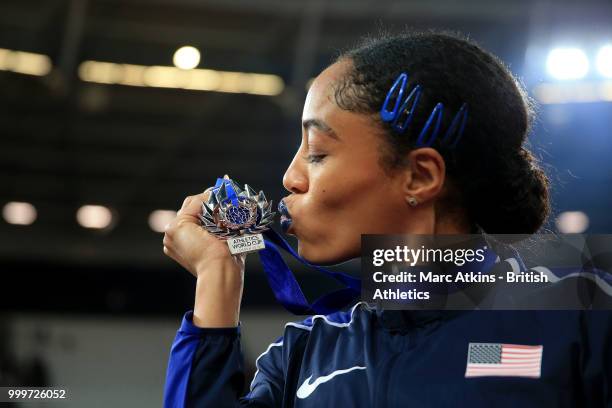 Captain Queen Harrison kisses her medal as Team USA celebrate victory during day two of the Athletics World Cup London at the London Stadium on July...