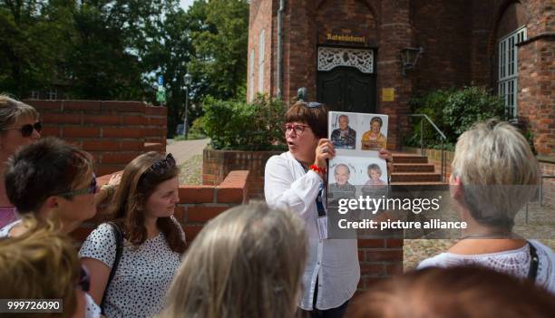 City tour guide Verena Fiedler explains a location where the ARD soap opera 'Rote Rosen' was shot during a tour in Lueneburg, Germany, 30 August...