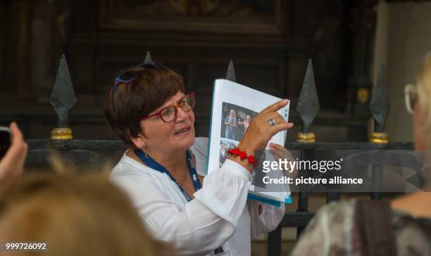 City tour guide Verena Fiedler explains a location where the ARD soap opera 'Rote Rosen' was shot during a tour in Lueneburg, Germany, 30 August...