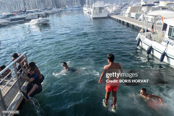 France suporters dive into the sea in Marseille, southern France, on July 15 after France won the Russia 2018 World Cup final football match between...