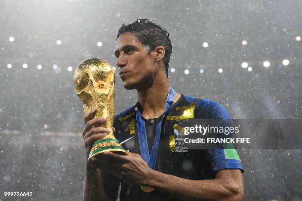 France's defender Raphael Varane holds the World Cup trophy after winning the Russia 2018 World Cup final football match between France and Croatia...