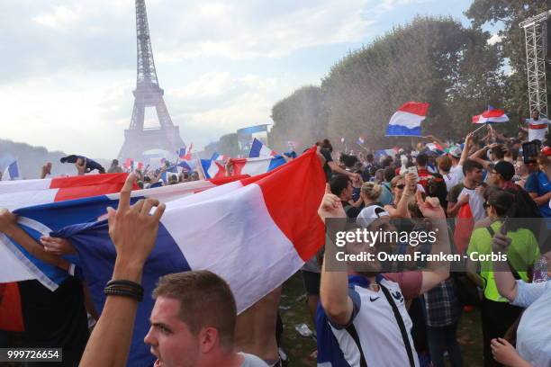 French fans celebrate victory over Croatia after their World Cup final, on July 15, 2018 on the Champs de Mars near the Eiffel Tower, in Paris,...