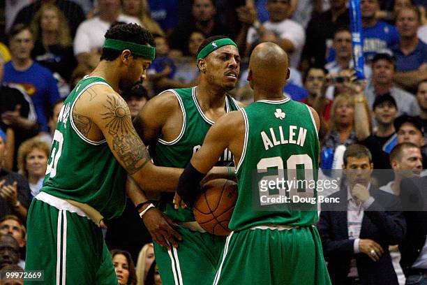 Paul Pierce of the Boston Celtics is restrained by teammates Rasheed Wallace and Ray Allen after Dwight Howard of the Orlando Magic comitted a...