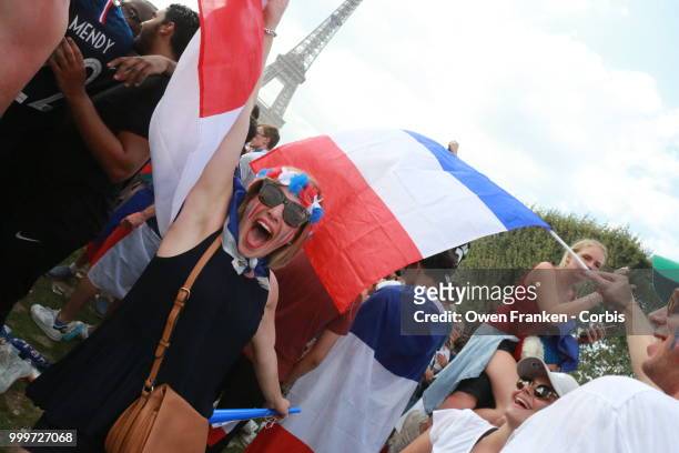 French fans celebrate victory over Croatia after their World Cup final, on July 15, 2018 on the Champs de Mars near the Eiffel Tower, in Paris,...