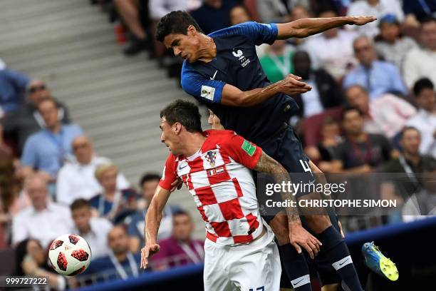 Croatia's forward Mario Mandzukic vies with France's defender Raphael Varane during the Russia 2018 World Cup final football match between France and...