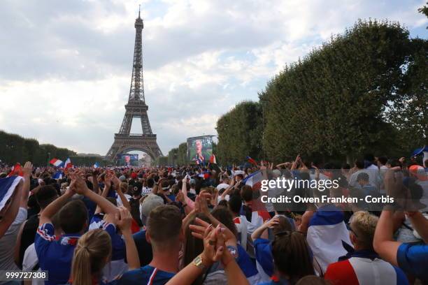 French fans celebrate victory over Croatia after their World Cup final, on July 15, 2018 on the Champs de Mars near the Eiffel Tower, in Paris,...