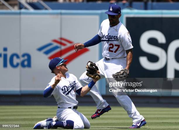 Enrique Hernandez of the Los Angeles Dodgers makes a catch on a popfly as teammate Matt Kemp tries to avoid a collision during the second inning of...