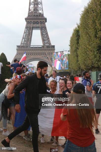 French fans celebrate victory over Croatia after their World Cup final, on July 15, 2018 on the Champs de Mars near the Eiffel Tower, in Paris,...