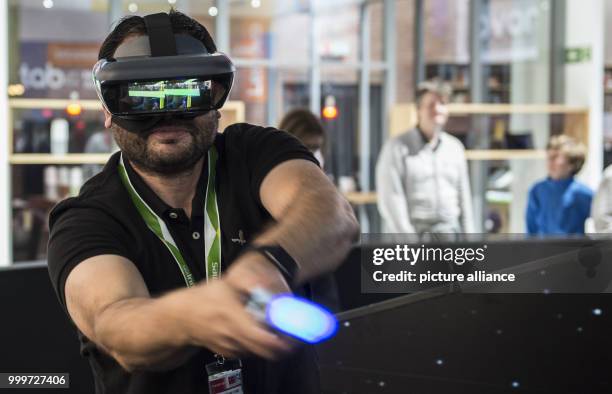 Visitor plays the game 'Jedi Challenges' wearing virtual glasses at the stand of Lenovo at the international electronics fair IFA in Berlin, Germany,...