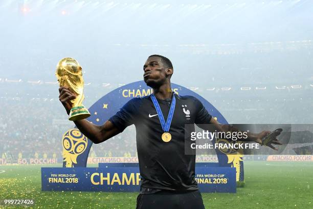 France's midfielder Paul Pogba celebrates with the World Cup trophy after the Russia 2018 World Cup final football match between France and Croatia...