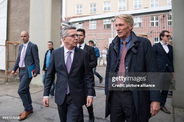 German Minister of the Interior Thomas de Maiziere and Hubertus Knabe , director of the memorial, leave the memorial site Hohenschoenhausen of the...