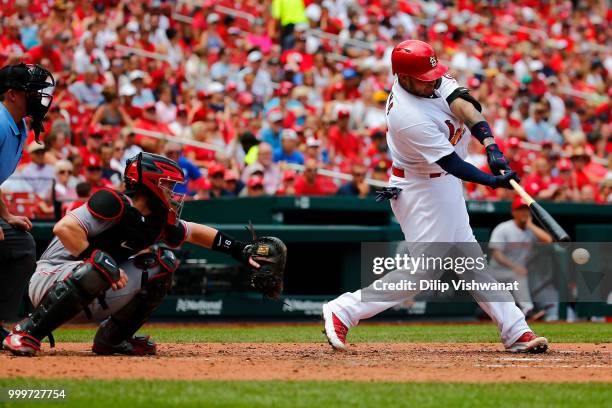 Yadier Molina of the St. Louis Cardinals hits an RBI single against the Cincinnati Reds in the fourth inning at Busch Stadium on July 15, 2018 in St....