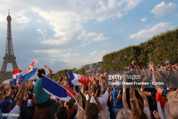 French fans celebrate victory over Croatia after their World Cup final, on July 15, 2018 on the Champs de Mars near the Eiffel Tower, in Paris,...