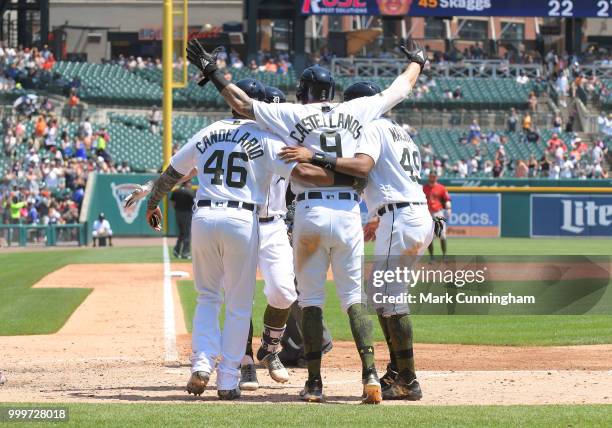 Jeimer Candelario, James McCann, Nicholas Castellanos and Dixon Machado of the Detroit Tigers celebrate a grand slam home run hit by McCann while...