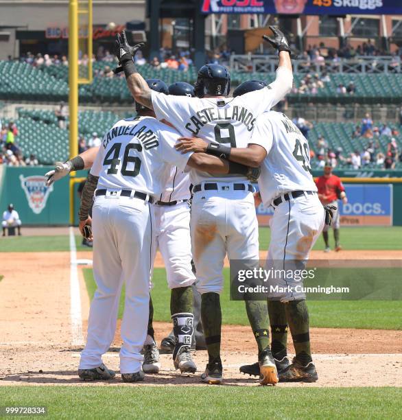 Jeimer Candelario, James McCann, Nicholas Castellanos and Dixon Machado of the Detroit Tigers celebrate a grand slam home run hit by McCann while...