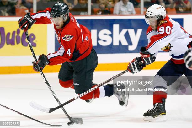 Taylor Hall of the Windsor Spitfires shoots the puck while being defended by Kelsey Tessier of the Moncton Wildcats during the 2010 Mastercard...