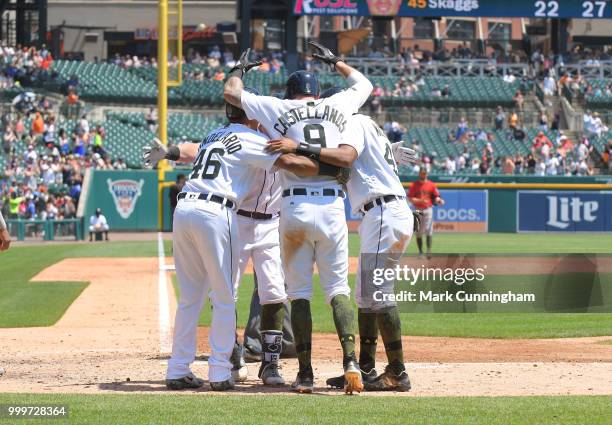 Jeimer Candelario, James McCann, Nicholas Castellanos and Dixon Machado of the Detroit Tigers celebrate a grand slam home run hit by McCann while...