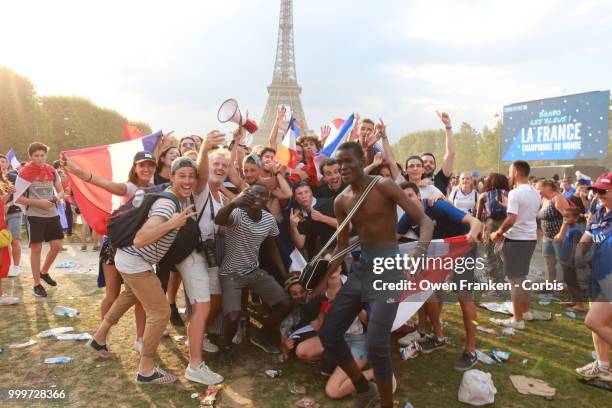 French fans celebrate victory over Croatia after their World Cup final, on July 15, 2018 on the Champs de Mars near the Eiffel Tower, in Paris,...