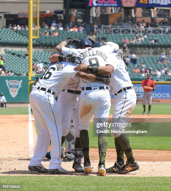 Jeimer Candelario, James McCann, Nicholas Castellanos and Dixon Machado of the Detroit Tigers celebrate a grand slam home run hit by McCann while...