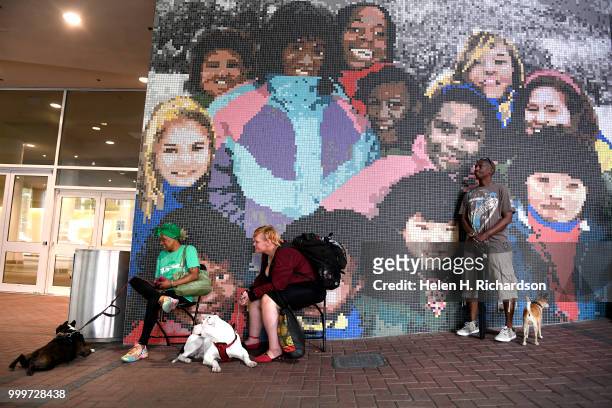 From left to right Kathleen Beane, with her dog Chainz, Lisa Shober, with her dog Pretty Girl and Delisa Ross with her dog Tiko Brown wait in line to...