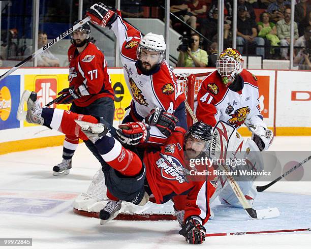 Mark Barberio of the Moncton Wildcats pulls down Dale Mitchell of the Windsor Spitfires during the 2010 Mastercard Memorial Cup Tournament at the...