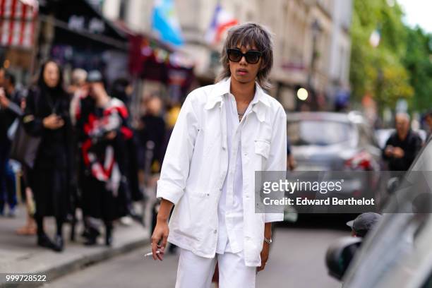 Guest wears a white jacket and a white shirt, outside Yohji Yamamoto, during Paris Fashion Week - Menswear Spring-Summer 2019, on June 21, 2018 in...