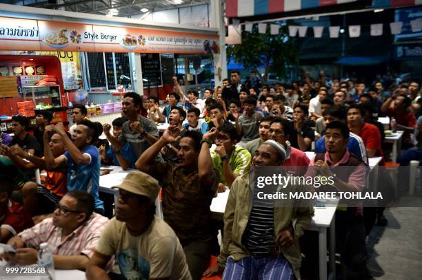 Crowd of Thai Muslim people watch at a live television broadcast of the Russia 2018 World Cup final football match between France and Croatia at a...