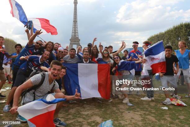 French fans celebrate victory over Croatia after their World Cup final, on July 15, 2018 on the Champs de Mars near the Eiffel Tower, in Paris,...